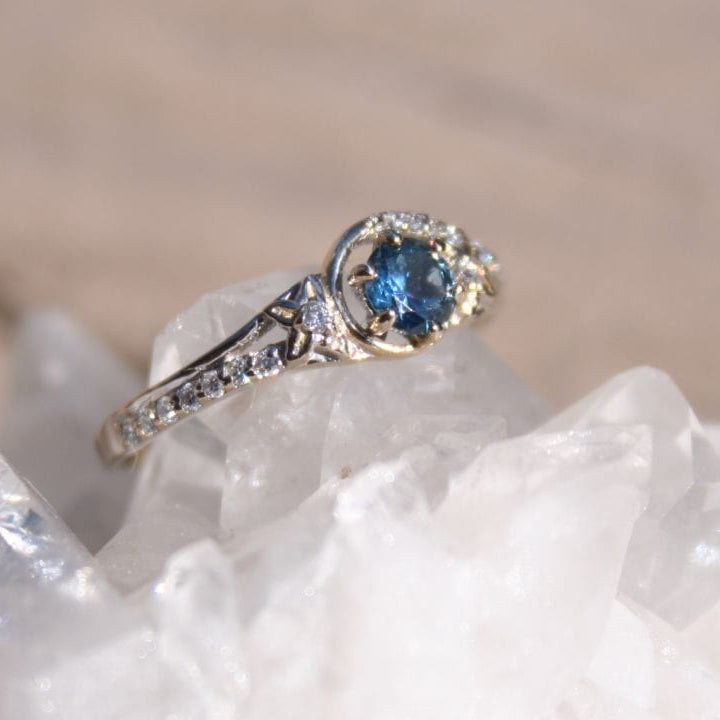 Engagement ring with blue Montana sapphires and flower accents 