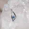 Silver pendant with blue Montana sapphire in unique modern design. 