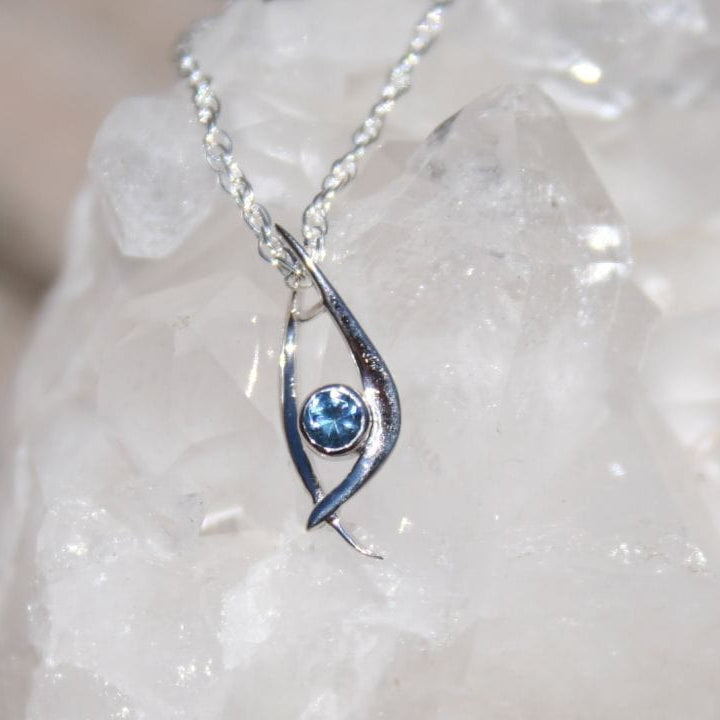 Silver pendant with blue Montana sapphire in unique modern design. 