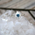 Blue sapphire ring with a filigree diamond shaped frame