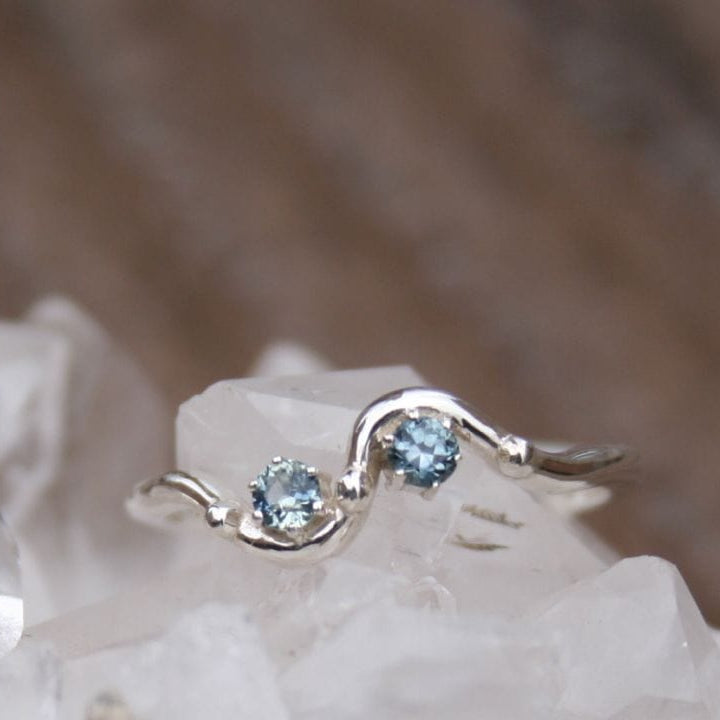 two blue Montana sapphires in detailed band ring. 