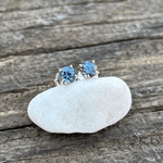 A pair of silver stud earrings with round blue Montana sapphires. Classic 4 prong settings with butterfly style backs.