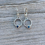 Silver hoop earrings with blue bezel set Montana sapphire