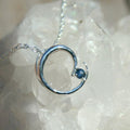 Silver circular pendant necklace with blue Montana sapphire 