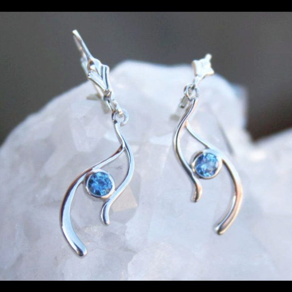 Silver earrings with blue Montana sapphires in a wavy design